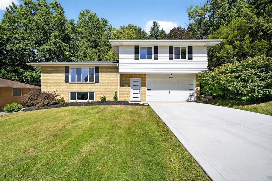 This Garfield Heights split-level home is in a league of it's own.  Fully renovated, this home features 3-bedrooms, 2.5-bathrooms with a lower level that could be used as a rec room or an additional bedroom.  The kitchen is a showstopper with top-of-the-line appliances, an impressive waterfall sink, a tucked away coffee bar and microwave, five-burner gas stove, luxury tile flooring, and a unique, live edge breakfast bar counter featuring a cherry wood slab sourced from Geauga County.  No detail was spared in the bathrooms that were tastefully designed featuring premium fixtures. Enjoy new flooring throughout, modern recessed lighting, and an eye catching fireplace with built-in 50" TV.  Outside you'll find a well manicured lawn and a fire pit in the backyard to enjoy as the summer nights wind down. Located on a quiet street with easy access to shopping and the highway this home has it all.  Schedule a private tour today.