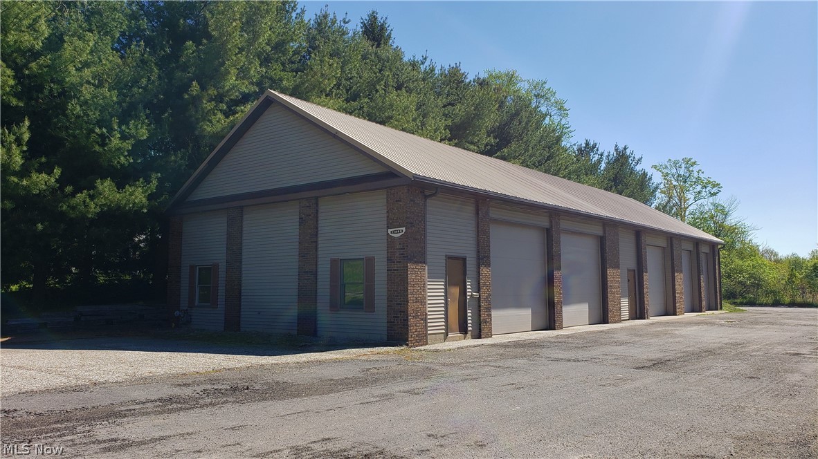 Original building (the rear portion) was built circa 1970. An addition was built in the 1990's. Details: Appx. 3600 sq. ft. of heated space on concrete slab. Natural Gas Tube Heating, Five 12' Overhead Doors, City Water, Half Bath, Semi-Public Waste Water Treatment System, Metal Roof, Grease Trap, 200 Amp Electric Service, Hot Water Heater, empty 48' storage trailer, Asphalt Paved Parking Lot, 432 sq. ft. exterior shed (former salt shed w/o doors). Property consists of 3 areas - Office Space (16' x 11') with storage space above, Main (80' x 35' less the office space) with 3 overhead doors and adjoining 1/2 bath, and Rear (34' x 29') with 2 overhead doors. Property has been exempt from Portage County Property Tax due to ownership by the township. Property will be assessed after transfer.