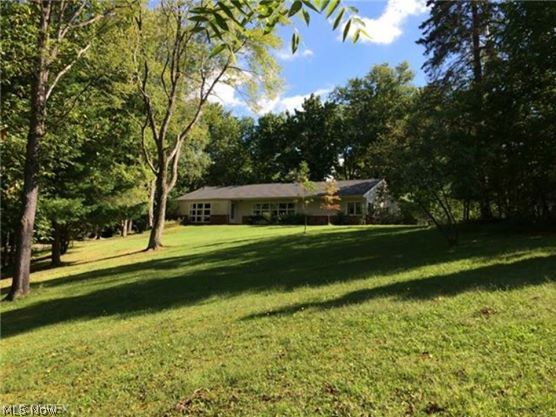 Looking for seclusion in Bath? Here it is! A winding driveway through the trees takes you to this sprawling hill top ranch home on over 2 acres where you will find fantastic veiws both to the front and rear of the home. Absolutely fabulous interior. Totally renovated throughout. Large and open floor plan surrounds the gorgeous stone fireplace. Lots of windows and light. Rich hardwood floors, upscale cabinetry and granite counter tops. Spacious living room with a wall of windows overlooking the gorgeous lot. Huge great room opens to the kitchen and eating area. Nice master suite with cathedral ceiling and glamour bath. Full basement, 2 car garage, beautiful setting and so much more! Nearly an acre of open meadow is fenced and includes a one car detached garage perfect for lawn equipment. Home has a 2 car attached heated garage. Updates include: 50 year roof shingles done in 2009, hot water tank, furnace and C/A. One of a kind!