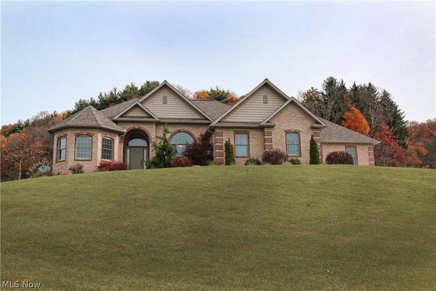 Country living minutes from town. This beautiful 2-tone brick Ranch with hillside walk-out is located on 5 acres. Custom built in 2009 by Miller Homes, this 3 bedroom, 2.5 bath home is situated for your enjoyment of the wonderful views. You will love the high-end finishes throughout the home including the Mullet cabinetry, granite counters, tiled backsplash, center island in the gourmet kitchen, custom range hood vent, Geothermal heat with radiant hot water heat in the garage and basement floors, Brazilian walnut hardwood floor. The walkout lower level is 14 courses high for 9 ft. ceiling heights and rough-plumbed for a bath and bar. The safe is perfect for all your collectibles. Step outside to the large paver patio in the lushly landscaped back yard and enjoy a fire in the fire pit. The 3-car heated garage offers room for vehicles and storage. This home's open and airy floor plan is perfect for entertaining friends and family.