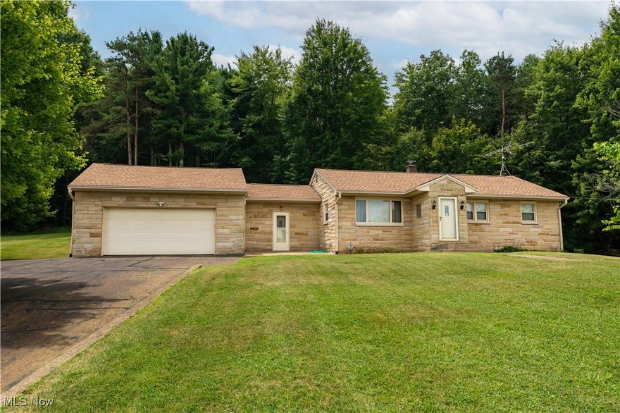 Welcome to 2122 Millerton St. SE in Canton South! This 3-bedroom, 1-bath ranch sits on 3 acres and offers a great layout with plenty of potential for your personal updates. Featuring 1,036 square feet of living space, propane heat, central air, and a charming stone exterior that adds curb appeal, this home combines comfort and potential! Relax in the screened-in back sunroom or take advantage of the impressive garage space—including a 2-car attached garage and an oversized 3-car detached garage with electric. Whether you need space for storage, hobbies, or extra vehicles, there's room for it all! The paved driveway leads to the home, with an additional cement drive to the detached garage providing even more parking options. Located just minutes from Route 30, you'll have easy access to local shopping and hospitals, and you're less than 30 minutes from Akron-Canton Airport. Close enough for convenience, yet far enough to enjoy peace and quiet. Don’t miss this unique opportunity!
