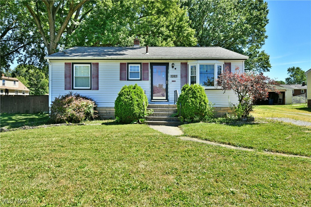 Start your next journey on the right foot with this perfectly cozy, three-bedroom Girard home, complete with two floors of finished living space for even more possibilities! Tucked away within a quiet neighborhood, the endearing residence presents its curb appeal to include a detached two-car garage and a bay window found alongside the front porch. A sizeable, fenced-in backyard includes a large storage shed and a raised rear patio. Inside, the sun filled living room brings plush carpets as a sculpted archway leads into the robust combined kitchen and dining areas. Tiled floors make quick work of the high traffic area while stainless steel appliances join a glass tiled backsplash to offset the high contrast countertops and cabinetry. Down the main hall, a colorfully appointed full bath showcases its updated vanity and tile lined shower. Three spacious bedrooms are trimmed in warm hardwood flooring as they provide ample closet space. Downstairs, the wood paneled central storage space includes laundry services. The finished bonus room wraps around for an impressive footprint, offering tons of rec space or potential spare bedroom.