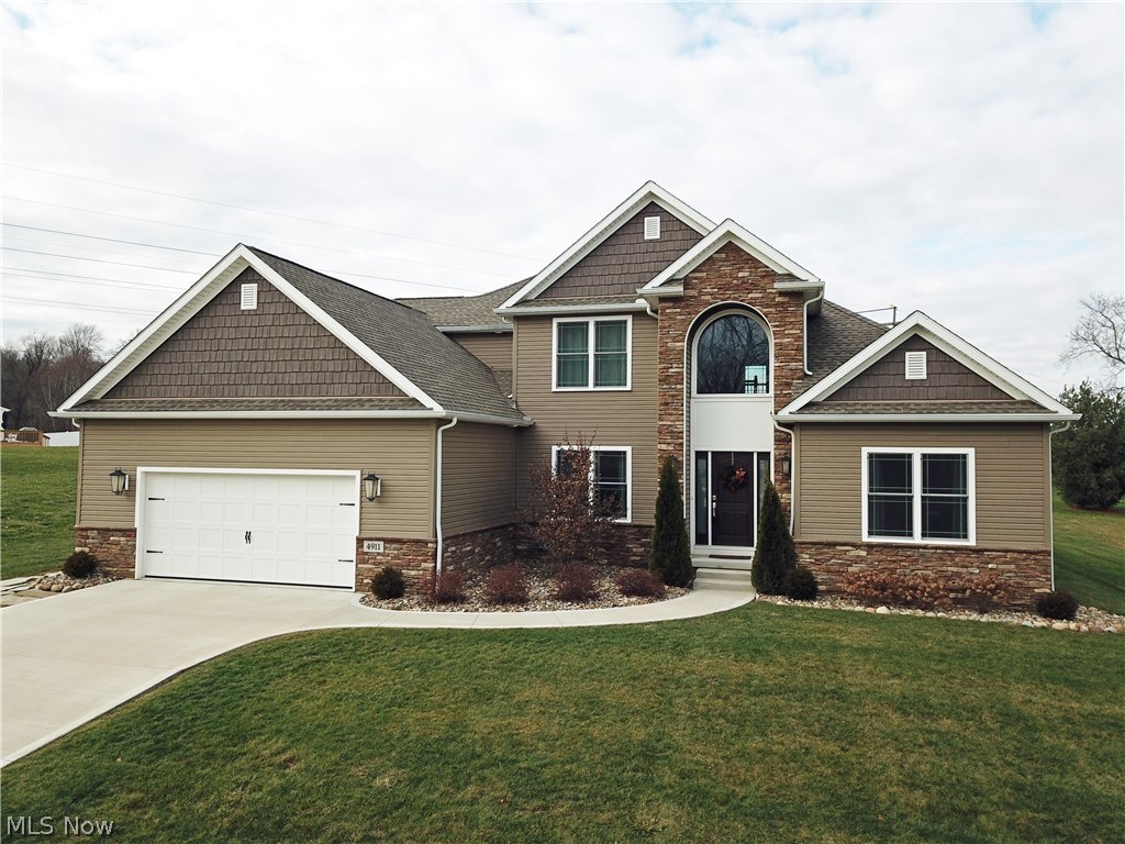 Your Custom-Built Dream Home is Here! Just the one you've been waiting for, it's sure to check everything off your wants list: 4 Bedrooms, 3.5 Bathrooms, 2-Story Great Room w/ Fireplace & Coffered Ceilings, Dark Hardwood Floors, 1st Floor Master Suite with Dual Walk-In Closets, Separate Toilet Room, Massive Walk-In Shower, Jetted Tub, 1st Floor Laundry Room, 1st Floor Office, Open Floor Plan, Gorgeous Eat-In Kitchen w/ Granite Counter-tops, Walk-In Pantry, Stainless Steel Samsung Kitchen Appliances, Covered Back Porch, Open Staircase and with Catwalk/Balcony with Iron Spindles, Complete Finished Basement with Theater Room, Work-Out Room, Built-In 2-Story Playhouse, Large Open Rec Room & Full Bath. Garage is oversized 2 car, almost 3 car as it has an extra bay for workshop or toy storage. This home was built in 2014 so it's almost brand new! Located in Sugar Maple Hills one of Brimfield's most desired neighborhoods! Call today to schedule your personal tour! This one is priced very aggr