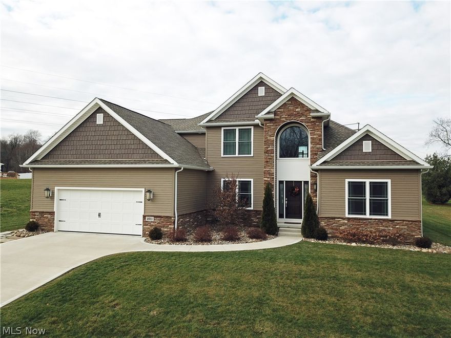 Your Custom-Built Dream Home is Here! Just the one you've been waiting for, it's sure to check everything off your wants list: 4 Bedrooms, 3.5 Bathrooms, 2-Story Great Room w/ Fireplace & Coffered Ceilings, Dark Hardwood Floors, 1st Floor Master Suite with Dual Walk-In Closets, Separate Toilet Room, Massive Walk-In Shower, Jetted Tub, 1st Floor Laundry Room, 1st Floor Office, Open Floor Plan, Gorgeous Eat-In Kitchen w/ Granite Counter-tops, Walk-In Pantry, Stainless Steel Samsung Kitchen Appliances, Covered Back Porch, Open Staircase and with Catwalk/Balcony with Iron Spindles, Complete Finished Basement with Theater Room, Work-Out Room, Built-In 2-Story Playhouse, Large Open Rec Room & Full Bath. Garage is oversized 2 car, almost 3 car as it has an extra bay for workshop or toy storage. This home was built in 2014 so it's almost brand new! Located in Sugar Maple Hills one of Brimfield's most desired neighborhoods! Call today to schedule your personal tour! This one is priced very aggr