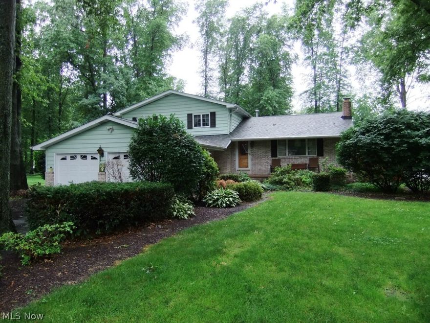 Spacious 4-Level Split, includes 4 bedrooms with basement.  Garages galore: 2-car attached garage plus 2-car detached, and shed.  Mammoth 25'x25' family room with fireplace, great for entertaining.  Also, living room with fireplace.  Huge fenced lot enhanced by deck, brick patio and hot tub.  Fourth bedroom on the lower level would be great for a home office.  Home Warranty.