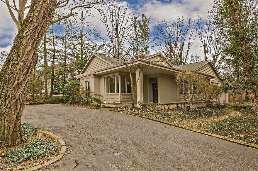 Luxury living at a fabulous price in Shaker! Sitting amidst a privately wooded lot, this mid-century modern home is nestled on a 1.4 acre lot across from Horseshoe Lake. Enter into the marble foyer and open floor plan, starting with the dining room showcasing a finely detailed built-in cabinet. The kitchen features an eat-in area, vaulted ceilings, skylights, beautiful walnut cabinetry, black granite countertops, a totally renovated Sub Zero refrigerator, and newer stainless steel appliances (less than five years old). Entertain in the family room with a rich hardwood floors, a wall of built-ins and a wet bar, a white stone fireplace, as well as sliding doors leading to an oversized back patio that overlooks the back lot. The first floor master suite offers a luxurious mosaic-tiled sunken tub, as well as his/her sinks and walk-in closets. Upstairs, you will find three bedrooms with fantastic built-ins and plenty of closet/storage space. Two bedrooms share a Jack and Jill bathroom, whil