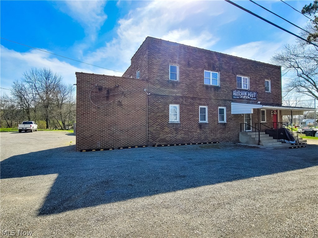 *** Absolute Auction ** May 19, 2022- 12:00pm **This popular, longtime, well established bar and grill located in Robertsville, Ohio known as the Hitchin’ Post Lounge features a two story commercial brick building with approx. 3/4 acre lot having plenty parking, fenced outdoor patio with fire ring and tables, full basement, heat pump, central air, 200 amp electric, fully equipped kitchen, stage, dance floor, acoustical ceiling, TV projector & screen, horseshoe bar, tables, chairs, walk-in cooler, all goes along with. A popular poker run spot. Also second floor with 2 apartments for additional income (presently rented). Sells all together. Many possibilities. Commercial / Business Opportunity. Convenient location right off Rt. 30. Property open for viewing at 10:00 AM, auction day.