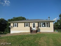 This cute ranch home has many newer features. When entering, your eyes will be drawn to the wbfp. What a great way to spend the coming cooler evenings! Sliders lead from the dining area to a large rear deck, which overlooks the huge back yard-perfect for that peaceful morning cup of coffee. Each of the three bedrooms has a ceiling fan. The lower level is finished, with a separate living area and full bath with shower. There’s even a separate doggy bath for your favorite 4-legged friends! All of this is located on a 1 acre lot! Schedule your showing today!