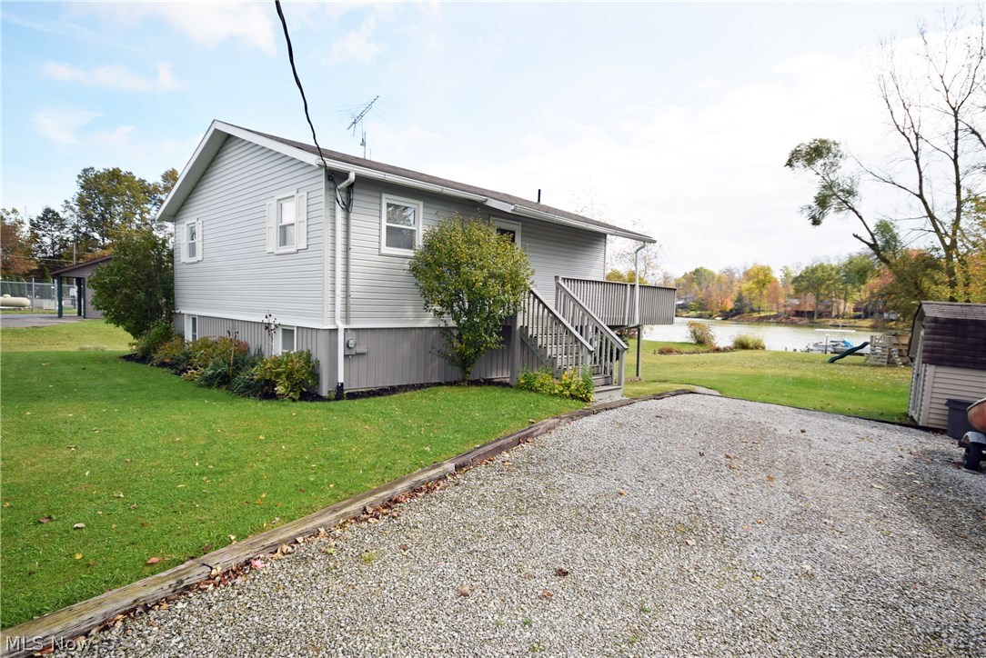 Exceptional condition with this 2 bedroom, 2 bath Cinnamon Lake home. Convenient walk out from kitchen onto walk-out covered concrete patio viewing the lake. Nice relaxing deck and private dock area. Great fishing on quiet lake, friendly community for year round activities. Nice appliances include refrigerator, stove/oven, microwave, dishwasher, garbage disposal, washer and dryer. Great storage area, 2nd flue if a wood burning fireplace is desired. Tasteful neutral decor, very clean home. Vacant lot #498 Carum Place included. Great opportunity! Call if you need fee schedule emailed to you or list of amenities. Last 3 photos are of vacant lot. This Realtor would love to own this site!!