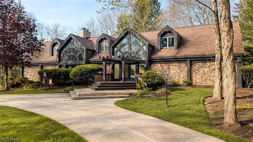 Welcome to this custom-built Contemporary Tudor, offering a unique blend of timeless character and modern functionality in a convenient location in Ghent,Ohio. From the moment you arrive, the striking architecture, rich exterior materials, and dramatic entry create a lasting impression.

Inside, the thoughtfully designed layout is enhanced by grand windows that fill the home with natural light, creating a bright atmosphere throughout. The main level features a private owner suite, offering an en-suite bath. Spacious living areas flow seamlessly including a spacious deck with a number of access points overlooking the backyard, perfect for outdoor dining, entertaining, or relaxing. The partially fenced yard offers added flexibility for a variety of outdoor needs.

Upstairs, you'll find three additional bedrooms along with a versatile home office that can easily serve as a fifth bedroom or flex space. With 4.5 baths throughout, the home offers both comfort and functionality.

The partially finished walkout basement expands the space even further, with endless possibilities for recreation or entertaining.

Combining distinctive architectural design, grand window features, and abundant natural light, this home offers a rare opportunity to own a truly unique property in a convenient location near shopping, dining, and major routes.