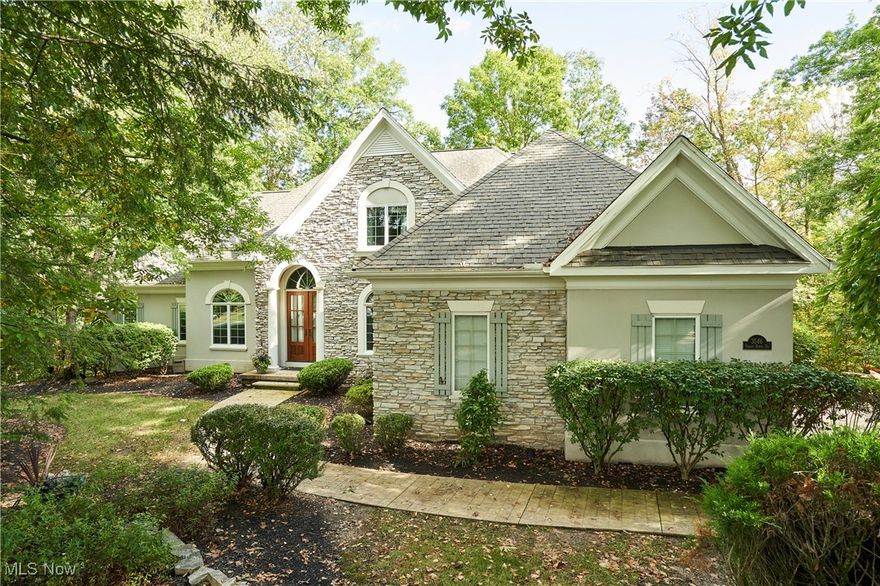 Nestled among the trees in Richfield's Glencairn Forest is this 5-bedroom 4.5 bath colonial with an updated light-filled kitchen, 2 first floor primary suites & lofty wooded views from every angle. Enter through gorgeous wood double doors to a dramatic foyer. A cozy den is to the left enclosed by french doors w gas FP & custom wood built-ins. The lovely & open dining room w maple floors, wainscoting & a large window showcasing private views. Beautiful sunken great rm w tray ceiling, floor to ceiling stone gas fireplace flanked by built-ins & large windows showcasing a private SE wooded view. The white cabinet kitchen was designed with these views in mind; it is surrounded by windows & filled with light. Crown molding, undercabinet lighting, large contrasting island, suite of stainless-steel appl., walk-in pantry, built-in bench in dinette & sitting area w a door leading to the composite deck ('21) that makes you feel like you are in a treehouse. Steps from the deck lead down to the side yard & patio area containing sliding glass doors to the walkout LL. There is a second 1st floor BR w an en-suite full bath. Generously sized at 20x16, the primary suite has a tray ceil., a door leading to the deck, large en-suite bath w granite counters, soaking tub, tile steam shower w frameless glass enclosure, 2 walk-in closets & WC. A laundry room w sink & a half bath round out 1st flr layout. Upstairs find 3 BRs, 2 that share a jack & jill bath & a 3rd w tented ceiling, skylight & large closet & updated carpet '22. The walkout LL feat. large living & sitting rooms w LVT floor & a slider leading to concrete patio. Partial kit. feat. granite counters, wall oven, refrigerator & wine cooler. Full bath w tile shower. This home also feat. a 24 x 26 home gym. Lovely 3-car garage w epoxy floor & stylish cabinetry. Newer HVAC & hot water tanks. Glencairn Forest offers walking trails, tennis court, playground & is close to parks, highways & the award-winning Revere school system.