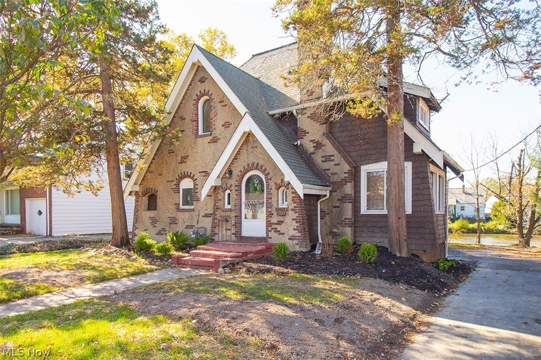 This stunningly renovated Tudor colonial is a rare opportunity for a private lake front property in the Parma Circle! Tucked away on a wooded lot on the edge of the private lake, this beautiful colonial has been carefully restored to a modern dream home! Everything is new from the asphalt driveway to the gorgeous deep mahogany, engineered bamboo flooring throughout the main floor & the fully updated kitchen - plus everything in between! The renovated kitchen features brand new Shaker cabinets, granite countertops & all new stainless steel appliances! All the bathrooms have been completely updated as well with new tile, vanities, fixtures, showers & more! All throughout the home the updates are completed with high-end finishes to bring luxury into every room! Plus, in this already spacious 4 bedroom home, you’ll have even more room in the partially finished basement complete with new plank flooring! The updated mechanicals include complete rewire of electrical with new panel, entirely n