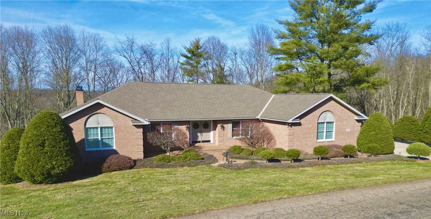 Stunning Custom 5BR Ranch in Woodcrest –Privacy, Space & Scenic Views! Welcome to this meticulously crafted custom ranch. Built in 2000, 4,000+ sq. ft. brick home blends elegance, functionality, & tranquility. Formal living, dining rooms, spacious kitchen, great room w/crown moldings. 2nd family room in lower-level w/wet bar as well as private office, & 3 BRs. 2 laundry areas. Expansive 2 level 80-ft decks with breathtaking wooded views. Whole-house generator, Two natural gas fireplaces.  Heated & cooled workshop with power & water. 2 Washers & 2 Dryers stay too!!! All this as well as 3 additional lots. The list just goes on & on. A rare opportunity to own a one-owner, well-loved, custom home in a serene setting—schedule your tour today!