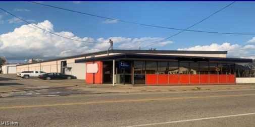 Incredible commercial opportunity at 207 9th St SW, Canton, OH 44702. This well-maintained property features a 11,600 SF warehouse/shop with a 1400 SF office space that includes a reception area, waiting room, and 4 offices, gas forced air and central air. The warehouse boasts a 2-ton rolling crane, truck well, updated lighting, gas heaters, 2 restrooms, tool room, storage mezzanine, 4% grade.17-18' ceiling height, Asbestos abated in 2021. Door sizes are 12x13, 12x14 and 12x12.6 it's perfect for various business needs. Well-maintained building with recent roof updates, security cameras, replaced storm drain in parking lot, ample parking, 2013 energy efficient lighting and a spacious .54-acre lot. Zoned for various uses with public utilities, this property presents a lucrative opportunity for investors or owner-occupants. Good area with easy access to Downtown Canton, I-77 and Rt 30. Benefit from the convenient location offering easy access to RT 30 and I-77.