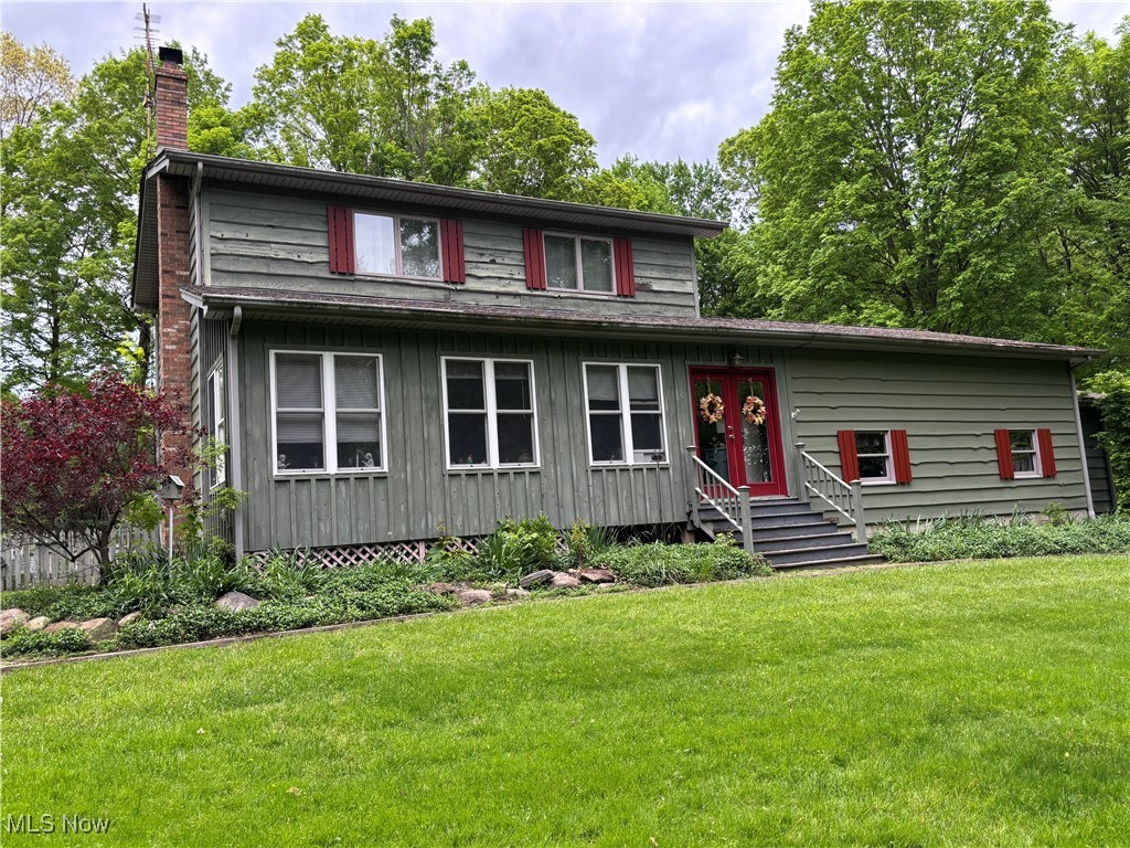 Nestled on 5 private acres, this secluded home is waiting for YOU! The home features a private, tree lined driveway with so many outdoor features that will have your green thumbs enticed. A mini covered bridge takes you to the garden area and large deck off of the kitchen. Also in the back yard is a 2.5 detached garage, woodshed, gazebo and a rustic cabin. The cabin is a perfect setting to relax and take in the tranquility of the outdoors. When entering the front door, you step into the screened-in porch that sets the tone for the home's welcoming charm. The porch is perfect for your morning coffee and winding down in the evening. The charming living room with wood burner, leads to a country kitchen and half bath. Next is the huge family room with wooden floors and ceilings. This large family room has two thoughtfully designed nook areas that add charm and functionality. One serves as a convenient pantry and the other can be utilized for a bar area, ideal for entertaining friends and family. The upstairs area features three bedrooms and one full bathroom. The primary bedroom has a large walk-in closet. The finished basement has another family room, and plenty of storage. The laundry room has a full bathroom which includes shower, vanity, and toilet. New gutter guards were done last month. Do not miss the opportunity to call this outdoor oasis your new home!