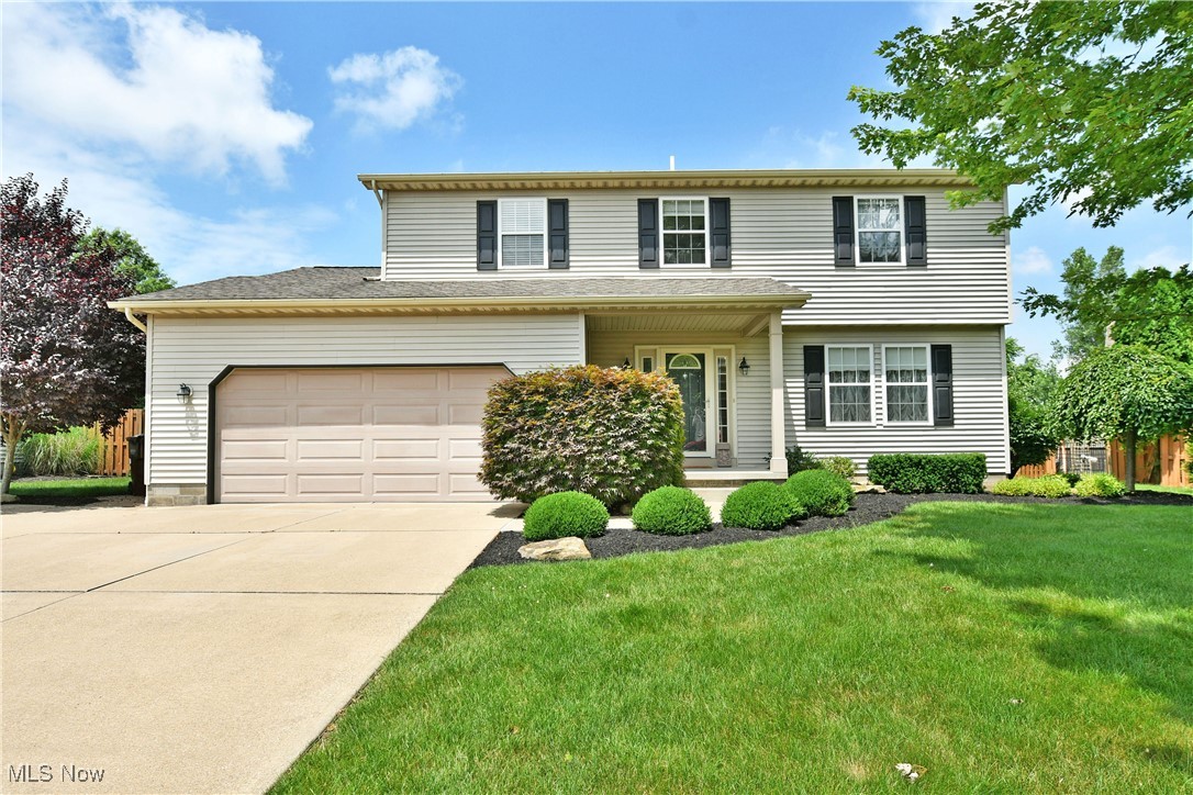 Artfully presented and impressively spacious, this four-bedroom Champion home checks all the right boxes with its stunning good looks from the inside out! Nestled away in a quiet neighborhood this residence quickly stands out with its park-like lot, immediately noticed by landscaped mulch beds and an extra wide cement driveway that leads up to the covered front porch. A deep-set and fenced-in backyard is the perfect summertime retreat as you take advantage of the large, covered patio that overlooks a stone walkway. A burbling hot tub adjoins a sizeable storage shed, each manicured in stonework. Inside, a sun washed foyer sweeps past the skylight adorned staircase as a welcoming family room is steps away. Formal dining sits around the corner with French doors opening to the patio. Hardwood styled flooring continues into the remarkable kitchen with its polished stone countertops and decorative lighting. The spacious rear family room completes the floor along with a charming half bath. Upstairs, four robust bedrooms branch from the landing, each with carpeted flooring and personal closet space. A rustic full bath joins them at mid hall. Meanwhile, the oversized master suite includes private vanity space, a walk-in closet and its own full private bath. A partially finished basement enjoys plenty of storage room along with laundry services. Call today to make this home yours!