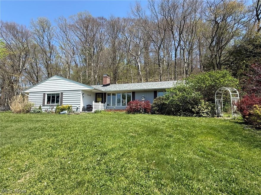 Well maintained 2 bedroom, 2 bath cedar ranch.  Open floor plan with hardwood floors and gas fireplace in the living room.  Beautifully updated kitchen with solid surface counters features an island breakfast bar with granite counters.  Updated main floor bathroom with quartz counters.  Spacious sun room provides panoramic peaceful country views.  Finished rec room in the lower level features knotty pine tongue and groove accent wall and wood burner.  Rear patio with built in wood grill.  2 car attached garage.  80 gallon hot water heater is a rental-$22 per month.  Updates throughout include RO system is new in 2017, updated electric in 2021, roof new in 2024, boiler new in 2026.  16 X 18 detached garage with new overhead door and attached storage area.   Peaceful 2.17+/- acre wooded country setting providing fantastic scenic views.  A must see!  Seller is reserving mineral rights.