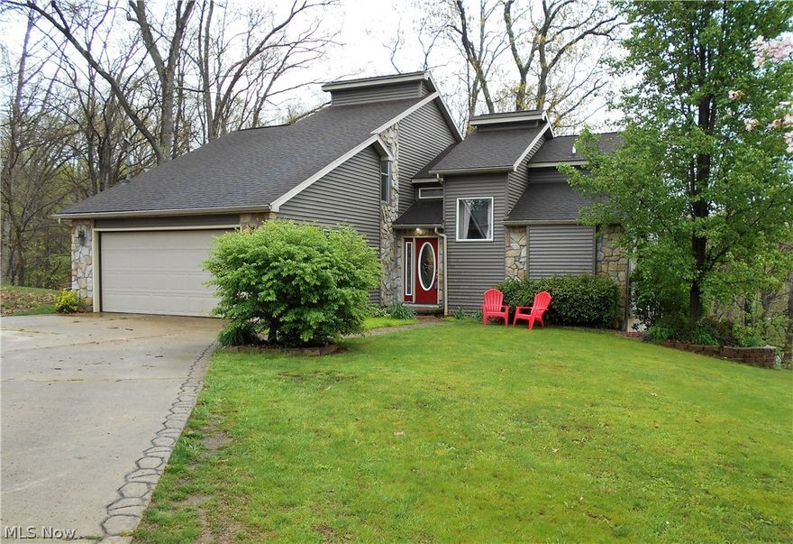 Contemporary style, 3-4 bedroom 3 1/2 bath home on just over an acre, outside the city limits. Long list of updates include new heat and A/C, flooring & paint throughout, updated baths, new deck, and so much more.  Full walk-out basement offer bedroom 4, a full bathroom, wet bar area, rec room with gas log fireplace, and additional storage. Master suite has skylights, deck access, master bathroom with soaking tub & stand-up shower. The upstairs has a brand new full bathroom, loft area, bedroom 2 with private deck, and bedroom 3 with chalk board wall (no closet).  Great outdoor living space, 2 car attached garage, private wooded setting, and tastefully decorated, make this a truly, move-in ready home.