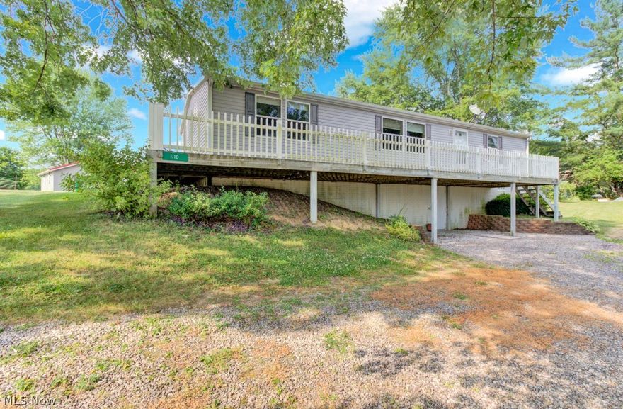 Immediate Possession on this immaculate and meticulously maintained 3 BD, 2-1/2 BA, ranch home situated on PRIVATE LAND and just a very short walk from Atwood Lake.  Taxed as real estate, this home sits on a full, partially finished walk out, poured walled basement, this level could easily be finished into second living quarters or additional living space for your family! Gourmet kitchen with walk in corner pantry, kitchen island with breakfast bar, all appliances, and an abundance of cupboard space. Split ranch layout with the large master suite on one end and 2 bedrooms and full bath on the other end. Spacious living room with windows that offer seasonal lake views and a sneak peek right now. First floor laundry has access from the kitchen and the 2nd bathroom. Downstairs you'll find a partially finished living area with lots of potential. Outside you'll love sitting on the large front deck where seasonal lake views can be seen. There's a driveway in front of the house and in the rear.  Out back you'll find a 24x26, 2 car detached garage with a workshop and a quaint sitting area with a small koi pond. Dock rights are across the street and within walking distance. Minerals are owned by previous owners years ago. Co-Op electric approx $266 mo, Atwood sewer $48 mo.