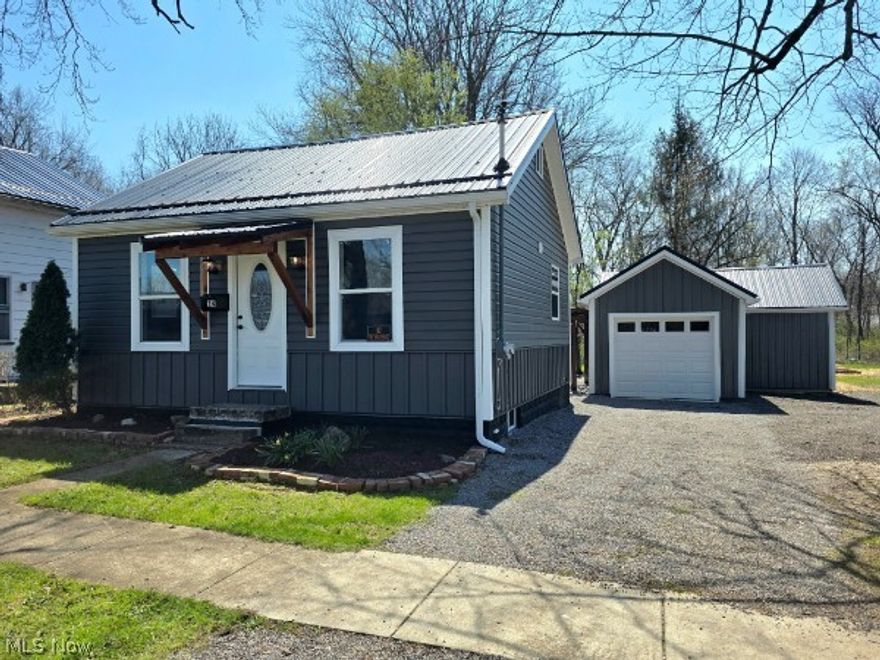 Enjoy a calm and peaceful setting at this beautifully remodeled home, thoughtfully updated inside and out. The spacious backyard is designed for relaxation and entertainment, featuring a large stone patio with fire pit, newly built deck with sliding glass access from the home, and a stunning pergola-covered gathering area. A winding path leads to a private fire pit area surrounded by mature trees, while the wooded rear portion of the property offers added privacy and a natural retreat with a walking path.  Inside, the open-concept layout showcases a bright and inviting great room with abundant natural light and seamless flow to the outdoor living space. The kitchen is beautifully finished with engineered concrete counters, farmhouse-style sink, custom soft-close cabinetry, and all new stainless appliances.  The home is equipped with efficient mini-split heating and cooling units for year-round comfort.  Additional upgrades include vinyl E-glass windows, updated lighting, and modern finishes.  The full basement offers freshly painted walls and floors,  and excellent storage or future finishing potential. Laundry hookups for both gas and electric.  The bathroom features a modern vanity with a lighted, press-to-adjust mirror, stylish fixtures, and clean, contemporary design. The finished loft area provides additional flexible living space—perfect for a bedroom, office, or bonus room.  Exterior improvements include durable steel siding with vinyl accents,  a detached 2-car garage with automatic openers and ample space for a workshop or hobby area.  Located in a quaint and friendly town offering a park, scenic waterfalls, and a variety of local restaurants, this move-in ready home combines comfort, style, and a peaceful setting. Schedule your showing today—this one is sure to impress.