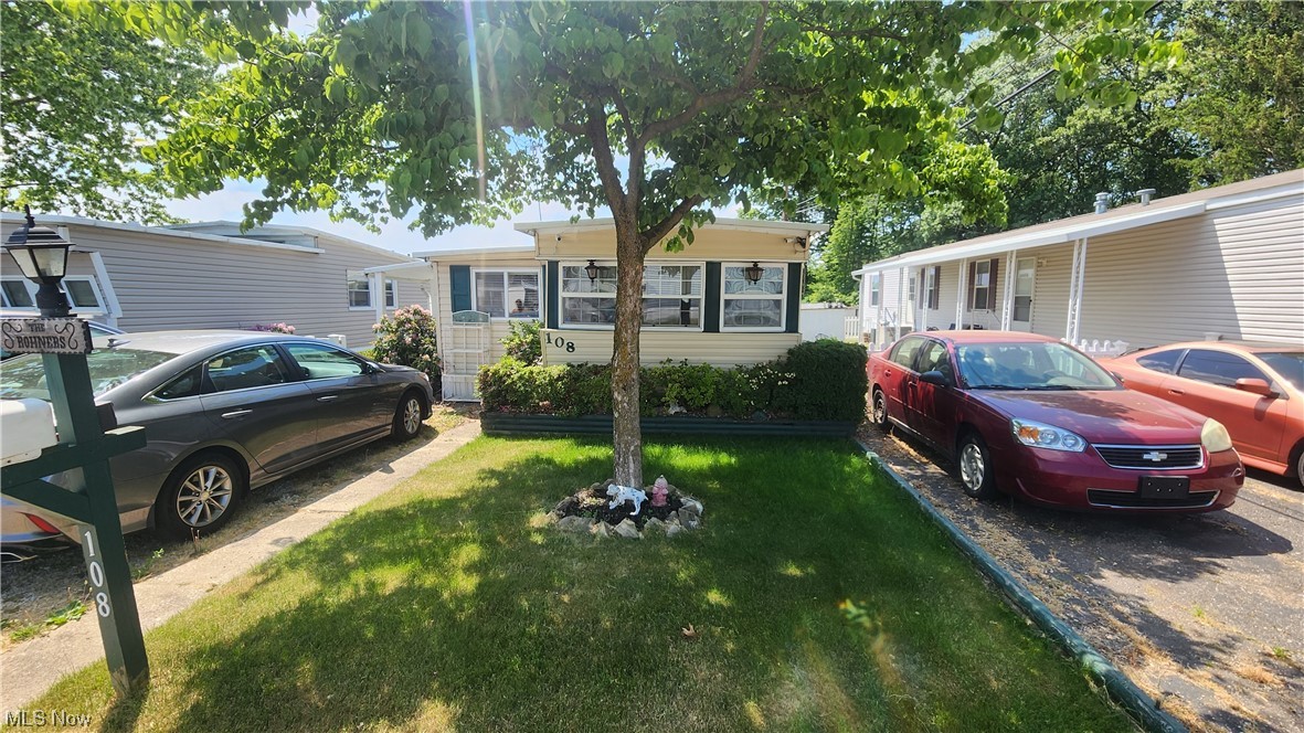 If you're looking to downsize but not lose comfort you should run and check this out! This two-bedroom, 1.5-bath mobile home has many upgrades and is so much larger than the other mobile homes you may be used to. With an actual front porch and a rear deck plus outside space to actually have family and friends over this is hard to beat. The kitchen has been recently updated as well as the main bathroom with a walk-in shower! Camodes are elongated and tall for ease of use. There are 2 parking spaces in the drive plus a space directly in front. The family has had large gatherings and many fun days playing in the spacious backyard and gathering on the large covered deck. The roof is a DACRAFT forever metal roof. Outside water and electric. There are 2 sheds plus a landscaping shed included. There is a pavilion in the park that has frequent holiday get-togethers.