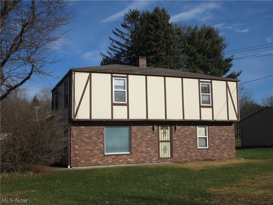 Great potential here!  This surprisingly spacious home has a great deal of living space as well as an attached 3 car garage with extras and it's all situated on 1.3 acres.  Fresh paint and new carpet will make a big difference here.  First floor full bath has a walk-in tub.  There is a second kitchen on the second floor also.  Selling to settle estate.  Located in Stow but with a Kent mailing address. Home Warranty included.  This home was just connected to the city sewer in May, 2017.