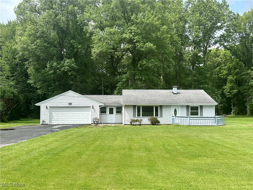 Enjoy serene country living in this charming ranch home situated on a sprawling one-acre parcel, but just minutes from essential amenities. Experience the ease of single-level living, where a spacious living room welcomes you and an inviting eat-in kitchen beckons for cozy meals. Two comfortable bedrooms provide restful retreats, while a versatile third room – perfect as an office, den, dressing room or extra bedroom – offers flexible space. Other highlights include a full bath and a mudroom with a laundry area and storage cupboards. With no steps to navigate, this house is practical, safe, and easy to clean and maintain. The oversized two-car garage comes complete with a work area for your projects. Outside, a welcoming front porch invites relaxation, a storage shed provides practical solutions, and a vast backyard bordered by mature trees creates a private, shaded oasis. Your peaceful retreat awaits!