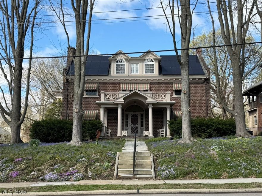 Step into one of Wooster's most remarkable homes-an exquisitely preserved 1915 Georgian estate offering nearly 6,000 sq ft of finished living space, where historic grandeur meets modern versatility. Zoned for both residential & home based business use, it features a gourmet chef's kitchen (2010 Ivan Weaver addition) with Wolf/Subzero appliances, granite counters, dual dishwashers & ovens, wine fridge, prep zones, & butler's pantry. Multiple living areas include a grand foyer, formal living & dining rooms (original chandelier, dining set, & chinaware included), sunroom, family room, rec room, & office spaces. The second floor offers an owner's suite w/ walk-in closet, sitting room, balcony, & Jack/Jill bath, plus three additional bedrooms (one currently a laundry room w/ drying cabinet). A finished third floor adds a large bedroom, cedar closet, & storage. The home can function as a 5 bedroom, though one bedroom is set up as a laundry/hobby room, explaining the difference from auditor records. The walk-out lower level provides exceptional flexibility-use it as a premium finished basement or as a home based business, with its separate entrance, address, lobby, offices, & conference room. Originally a yarn shop in the early 1900s & later a long running law office, it's ready for whatever you envision. Accessibility is prioritized with an elevator to the lower, main, & second levels, plus a ramped patio & accessible full bath. Outside, enjoy a manicured oasis with stamped concrete patio, outdoor kitchen, fountain, greenhouse, screened gazebo, garden beds, lush landscaping, & utility shed. Mechanical updates include a 2023 boiler, whole-house generator, solar panels, modernized plumbing/electrical, many updated windows, & more. Built by the Rhodes family (Wooster Brush Co. founders) & lovingly preserved by the Broehl family since 1983, this is a rare opportunity to live, work, & entertain in timeless style-you truly have to see it to appreciate everything it offers.