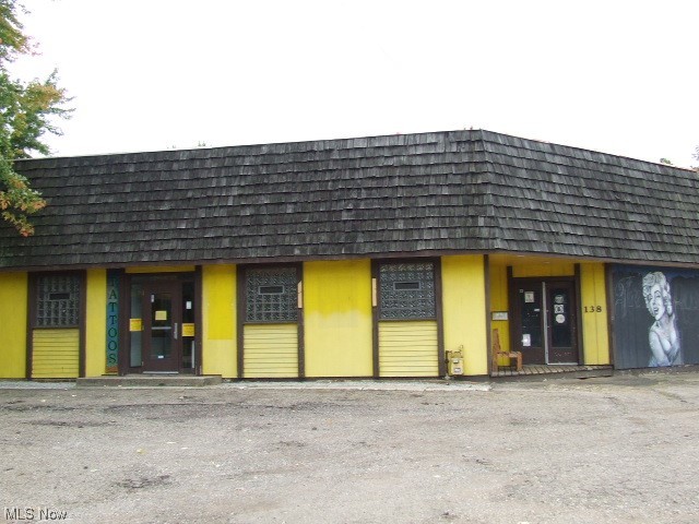 Large one-story building with lots of possibilities. Most recently used as a tattoo/piercing business for 29 yeas, it has also previously been a rollerskating rink, used car lot, carpenter's union and family health center. Inside main building has large welcoming front room, surrounded by 11 possible individual rooms/offices, 6 with sinks. There is a "back" area where several of the offices or storage areas are, plus a sauna that has never been used, shower/jetted tub room (drains have been capped) and two bathrooms. There's a former kitchen/laundry area, and additional work room behind first garage door. Also included are 2 more garages spaces with separate doors and 12+ parking spaces in private parking lot. Close proximity to expressway, downtown, bus line, gas station and many stores and businesses. The possibilities are endless! A little TLC could make this your dream business location!