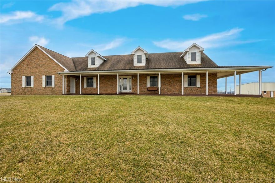 Welcome home to your amazing country estate with custom built 3260sf brick home with 4 bedrooms and 3.5 bathrooms! So many extras within this property! Private setting! Free Gas! The wrap around composite covered porch is perfect for enjoying the stunning sunsets here at "Top of the World!" Heated flooring in the 2.5 plus attached garage (with nature stone and access to the basement). The kitchen, laundry room, master bathroom and basement all have heated flooring too! Whole house audio system (all equipment will remain)! Gas fireplace! Back up generator! Open floor concept. First floor owner's suite with 12x7 walk in closet and french door lead you to the back part of the covered porch! 60x92 heated steel outbuilding (with 2 sinks and bathroom and 200amp electric service) is perfect for the business owner, collector, mechanic or hobbyist! Tons of parking and plenty of storage! Full unfinished basement with full bathroom too. What are you waiting for? This is a true gem for car enthusiasts or anyone seeking a serene retreat. Schedule your showing today!