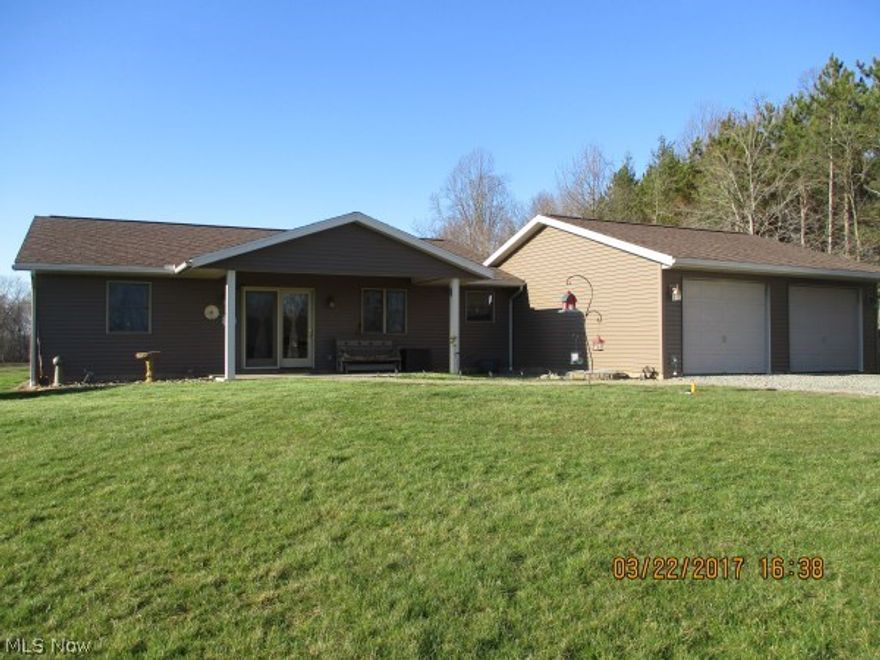 Immaculate 3 bedroom, 2 full bath ranch home on 5 secluded acres in East Guernsey School District offers an open floor plan with master suite separated from the other 2 bedrooms. The large living room has an adjacent snack center with pocket door, refrigerator, sink and plenty of cabinets. A new luxury kitchen has been added to this home and boasts Kraftmaid easy close mocha cherry cabinets with spice racks, lazy susans, garage tambour door for toaster/mixers, stainless steel appliances, recessed lighting, crown molding, pantry, and island/breakfast bar. Floating wood flooring in kitchen and dining room.  Master bedroom has 2 large closets and master bath with soaker tub and shower. New carpet throughout/hardwood floor underneath. 2-car attached garage with openers and propane heater can be entered from laundry and snack center or could be renovated into an in-law's suite. Front and back covered porches, private patio area, firepit, 12x24 storage shed (could be man cave or exercise roo