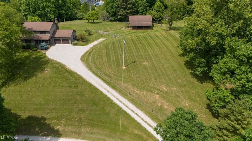 TOWN and COUNTRY location minutes from Belpre and Parkersburg. Park like setting invites privacy, beautiful wooded views and tranquility. This 10.68  acre farmette offers handsome cedar clapboard architecture and over 3,000 square of updated move in condition. The home features entry hall, fireside kitchen with keeping room, light filled rooms, extended porches for relaxing, full lower level walk out and recreation room. Additional amenities include fenced pasture, barn with stalls, storage shed and oversized attached garage. Did I mention walking trails and brook? The perfect dream retreat!