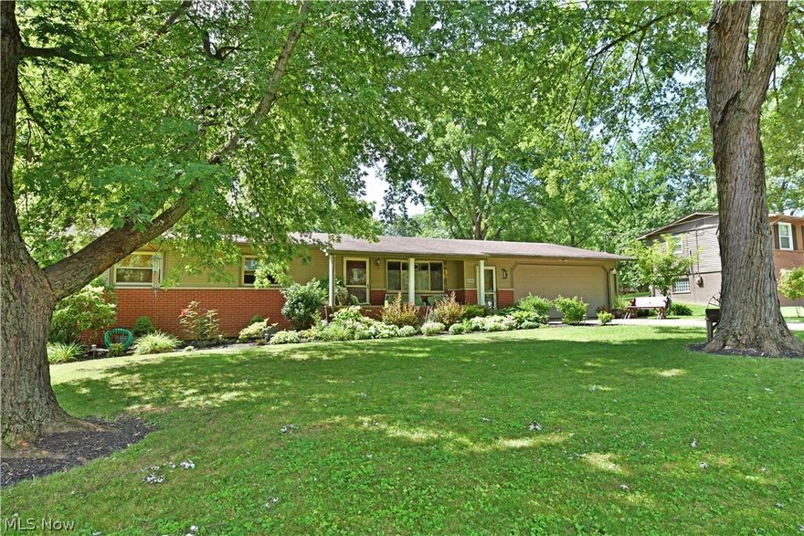 Lush landscaping and a park-like, garden filled backyard adorn this wonderful Warren ranch home! Nestled deeply into its tree-lined lot, this charming residence awaits for you to enjoy it scenic views inside and out. A relaxing, covered front patio brings you inside to find an open central layout with hardwood flooring dashing beneath your feet as it continues through the living room, dining area and down the hall into the trio of bedrooms. Bold, rich colors grace the walls as a large picture window helps to illuminate the area. Dining overlooks its own set of sliding doors that access the substantial patio area. The cozy kitchen holds white cabinetry and laminate countertops. Further down the main hall, a full bathroom joins the bedrooms to reveal tasteful tiled flooring and built-in closets. A full basement runs from the garage, offering additional storage and potential living quarters. Laundry and secondary commode complete the floor.. Howland Schools.