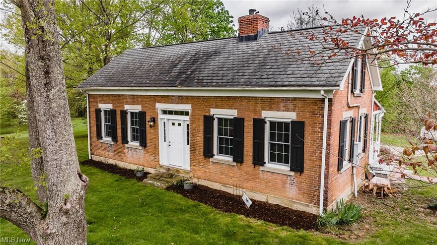 This amazing 1850's era country home is something that is not commonly found anymore; the home, sitting on 1.12 acres was built during the 1850's and still possesses the building style and charm that one would expect to find with this type of home.  Prior owners restored the home in 1997, and by using attention to detail were able to use reclaimed wood and period style "Pioneer Wavy Glass" in the new sunroom addition. The home has two bedrooms upstairs, and a full bath - while the main floor hosts a sitting room that captures the old ambience with a wood burning stove insert and truss style ceilings, a living room that could also be used as a third bedroom, a second full bath, a dining room, and the beautiful kitchen that hosts these amenities; a commercial grade gas range, dishwasher, newer refrigerator, beautiful white cabinets, and a not too often seen wood countertop. Also upgraded were the electrical system (200 amp), roof, and HVAC. Not forgetting the outside....there is a huge p