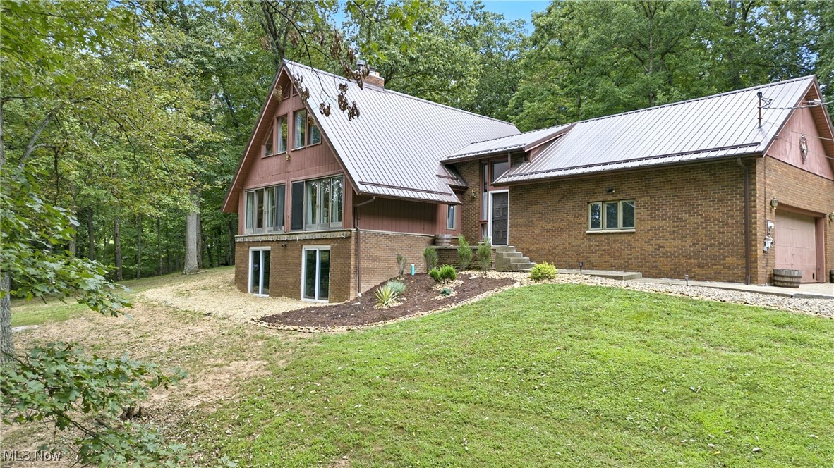 Welcome to this beautifully updated home offering the perfect blend of privacy, convenience, and modern living, priced well below appraisal – instant value & equity! Situated on 2.41 wooded acres with a private gated driveway, this property gives you the peaceful retreat you’ve been searching for while still being just minutes from Marietta, Athens, and Parkersburg. Step inside to find all new paint and flooring, a remodeled kitchen with wall oven and brand-new appliances, and updated bathrooms designed with style in mind. The spacious 1st Floor Master Suite boasts its own private patio—perfect for morning coffee or evening relaxation. The full finished walk-out basement provides even more living space, with endless options for entertaining, a home office, or recreation. 2 bedrooms upstairs, spacious loft, 4 bathrooms, and a 2-car garage, this home has room for everyone. Metal roof for long-term durability. Brand new septic system & new soft water system. Room to expand with a tiny home, treehouse, or outbuilding in the wooded area as well. This home offers the perfect mix of modern updates, natural beauty, and convenient location—don’t miss your chance to make it yours!