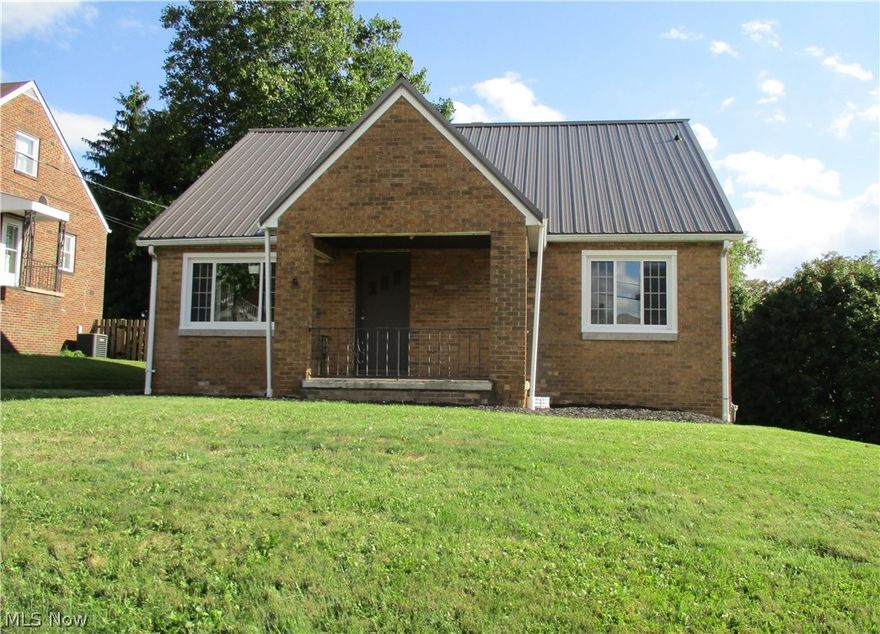 Fabulously Fresh !! Newly renovated from top to bottom this charming brick cape cod boasts a metal roof with 50 year warranty. New energy efficient windows throughout. Beautiful custom cabinets and granite counter tops.  All new fixtures in spacious main floor bath. Newly refinished hardwood floors on main floor. Second floor includes walk in closet and powder room. Basement has subway tile walls, new furnace, A/C and hot water tank.  Large front lot in quiet neighborhood with 1 car detached garage in back with work area below and amazing back yard with fireplace.