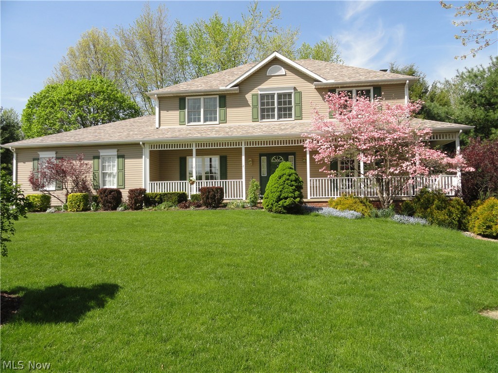 Fabulous Colonial in desireable Emerald Hills subdivision. Sitting high on the lot with a charming wrap around porch and an acre of land that includes a wooded area gently sloping down to a large pond. Custom built and meticulously maintained. Foyer entry with open staircase and gorgeous hardwood floors that continue into the formal dining room and eat in kitchen. Formal living room with french doors to family room that has a beautiful fireplace and is open to the kitchen. The kitchen has hickory cabinets, granite counters, stainless appliances plus there's a large walk in pantry, 1/2 bath and 1st floor laundry . The 14 x13 sun room has a cathedral ceiling, one slider to a patio and one to the deck porch all overlooking park like backyard. Master suite with glamour bath includes jetted tub, decorative window, separate shower and make up vanity. Walkout basement includes a rec room with stone fireplace, second room with built in bar and sink, full bath, and a storage area.