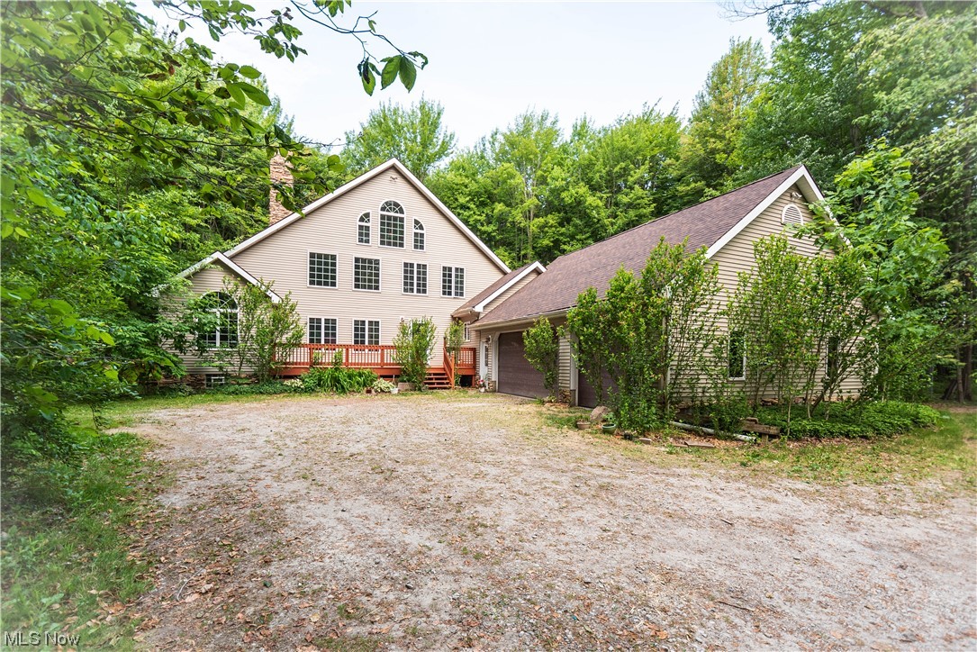 Calling All Outdoor Enthusiasts! Welcome to this well maintained home that is nestled among 27+ wooded acres (and there's a creek!) in Berkshire Schools. Walking into the house, you are greeted with a beautiful vaulted stone fireplace and huge windows. The spacious kitchen features lots of counter space is connected to the dining area which leads out to the back deck. There is a first floor bedroom that could be the master bedroom, has ADA accessible doors, with a connected en-suite that has a large walk-in shower. Upstairs is a second bedroom, which could be another master bedroom with a huge bathroom, and walk out deck to enjoy your morning coffee. The upstairs loft could be converted into a third bedroom (auditors website states 3 bedrooms). The basement is unfinished but has 9' ceilings, and wide open just waiting for you to put your finishing touches on it. To the right of the house, there is a HUGE workshop that can be used for all sorts of projects. There is 3 phase running to t