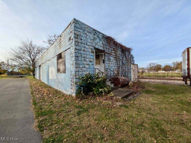 1942 square foot block building plus .465 acre industrial lot alongside the railroad. Owner states this property is M-1 Industrial with a variety of allowed uses.