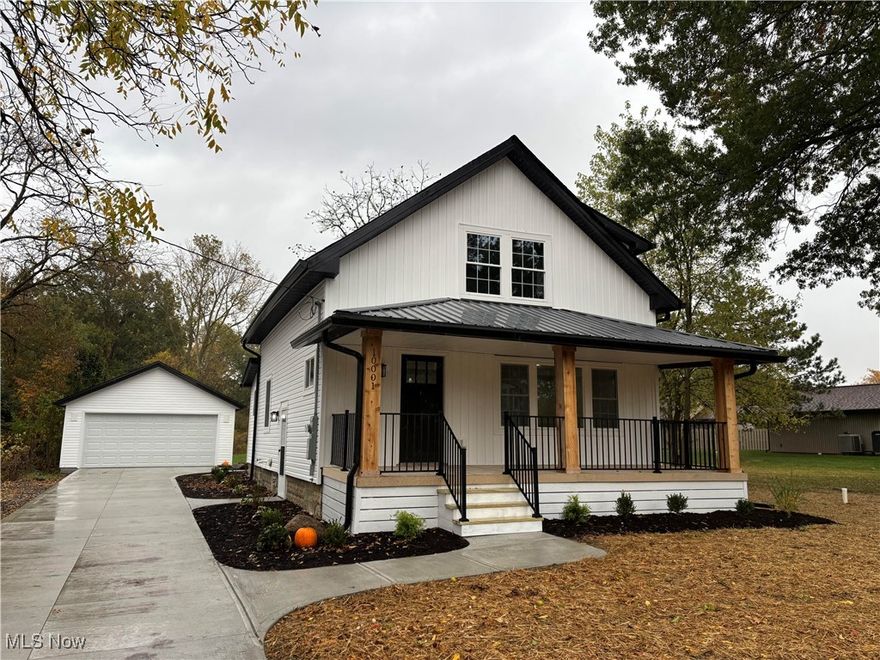 Exceptional Opportunity! This meticulously updated 3 bedroom, 2.5 bath home offers a rare blend of contemporary design, comfort, and generous outdoor space. Situated on nearly an acre, the property has been completely remodeled with high quality finishes and thoughtful upgrades throughout. From the moment you arrive, the brand-new concrete driveway and newly constructed two car detached garage set the tone for the attention to detail found within. Inside, the home features a bright, open-concept layout ideal for both everyday living and entertaining. The eat in kitchen is a true centerpiece, showcasing brand new stainless steel appliances, a spacious island, walk-in pantry, and ample counter space. Adjacent to the kitchen, a custom mudroom with built-in bench provides a practical and stylish solution for storing coats, shoes, and backpacks. A conveniently located first floor laundry room adds to the home's functional appeal. Every major system and surface has been updated, including a new roof, furnace, air conditioning unit, hot water tank, plumbing, electrical, windows, doors, flooring, and finishes - making this property truly move in ready. Upstairs, the home offers three comfortable bedrooms and two fully renovated bathrooms, including a serene primary suite complete with a walk-in closet and private en-suite bath. Outdoors, the expansive lot provides endless possibilities. Whether relaxing on the covered front porch or enjoying the scenic backyard, the space is perfect for gardening, play, or hosting gatherings. Located just minutes from Strongsville’s highly rated schools, shopping centers, dining options, and parks, this home combines modern living with suburban tranquility. Don’t miss your chance to own this beautifully renovated home on an oversized lot.