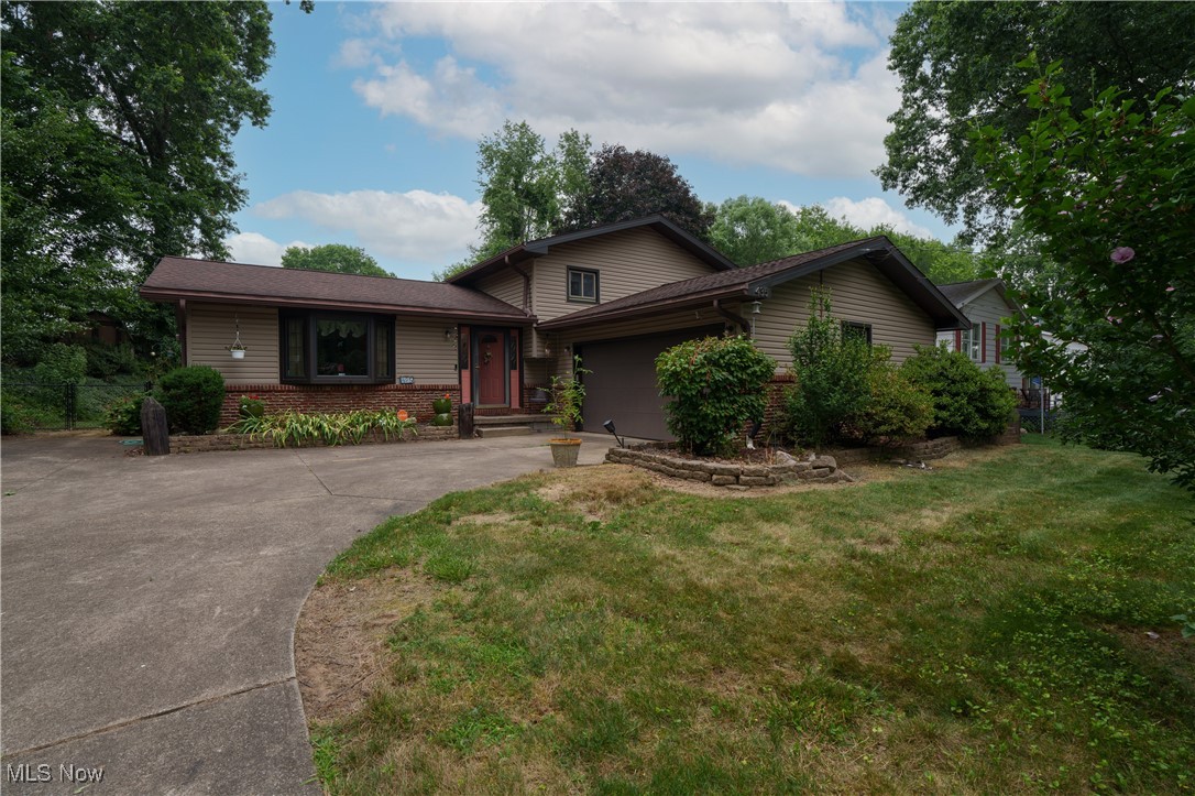 Located in the desirable Green Local School District, this beautifully maintained 3-bedroom, 1.5-bath home offers over 1,920 sq. ft. of comfortable living space on a picturesque 1/3-acre lot. From the moment you arrive, you’ll notice the inviting curb appeal framed by lush landscaping and flowering shrubs. Step inside to find a warm and welcoming interior featuring a spacious layout designed for both everyday living and entertaining. The heart of the home is the updated kitchen, showcasing rich wood cabinetry, granite countertops, tile flooring, and a large center island—perfect for meal prep and gathering. The adjoining dining room, with its elegant chandelier and vaulted ceilings, flows seamlessly into the living space below, highlighted by a striking stone fireplace that creates a cozy, rustic atmosphere. Upstairs, three generous bedrooms offer plenty of natural light and closet space, while the updated full bath blends function with style. An additional half bath on the main level adds convenience. Outdoors, enjoy your private backyard retreat—ideal for relaxing, gardening, or hosting friends and family. With mature landscaping, plenty of space to spread out, and an attached garage, this home checks all the boxes. Lovingly cared for and thoughtfully updated, this property is truly move-in ready and waiting for its next owner. Don’t miss your chance to call this home—schedule your private showing today!