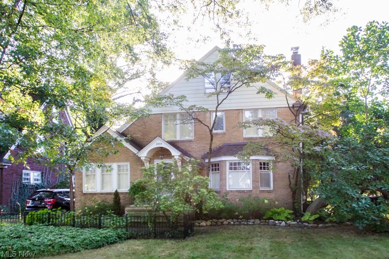 Charming brick Tudor home situated on a street lines with beautiful oak trees. Plenty of curb appeal bolstered by the paver driveway and stone-topped porch. Large living room and formal dining room. Crown Molding. Enjoy the living room with it's wood-burning fireplace. Home features a den that can also be used as a first floor office. Kitchen features granite countertops and an amazing farmhouse sink. This home features hardwood floors throughout, including the attic and a roof that's being entirely replaced in 2018. Relax on the spacious deck or on the patio in the the backyard while listening to the tranquil pond. Tall trees offer privacy and enjoy the beautifully tended landscape. Come and experience it all!