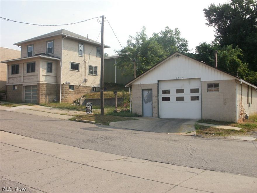 Nice 2 bedroom, 1.5 baths, with full basement,  1 car basement garage.  Additional block garage 56 X 24 with 3 phrase wiring, bathroom and gas heat, hoist ideal for the handyman or small business.   Also full hookup for a camper on side of building with 50 amp. electric service.