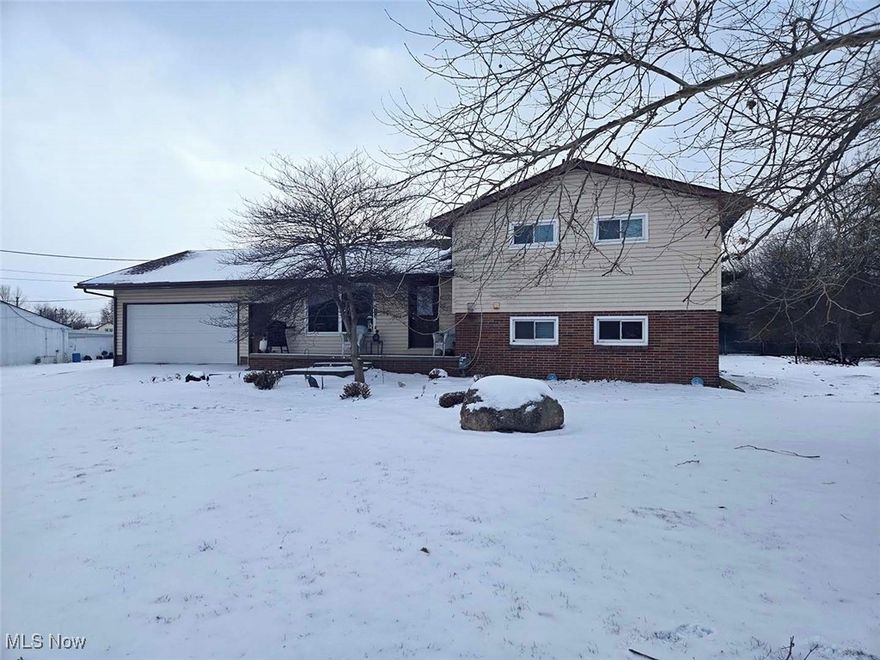 Solid Investment or Owner-Occupied Opportunity in Bolivar! This 1965 split-level home offers 2,640 square feet of practical living space on over half an acre. The vinyl-sided and brick exterior provides low maintenance, while the layout delivers functionality across three levels. The main level includes a living room, kitchen, and dining room. Upstairs, you'll find three bedrooms and a full bathroom. The lower level features a family room with a fireplace, a mudroom, and a half bath with laundry. A partial basement houses the breaker electric panel, gas forced-air furnace, and central air conditioning. The attached two-car garage adds convenience and storage. Public Water & Sewer. Currently rented month-to-month at $1,100, this property presents immediate cash flow for investors or the option to move in without waiting for a lease to expire. The 0.62-acre lot provides yard space and future possibilities. Conveniently Located Between Zoar & Bolivar w/ Easy Access to Highway. Priced to move and ready for its next chapter, whether that's continuing as a rental or becoming your next home.