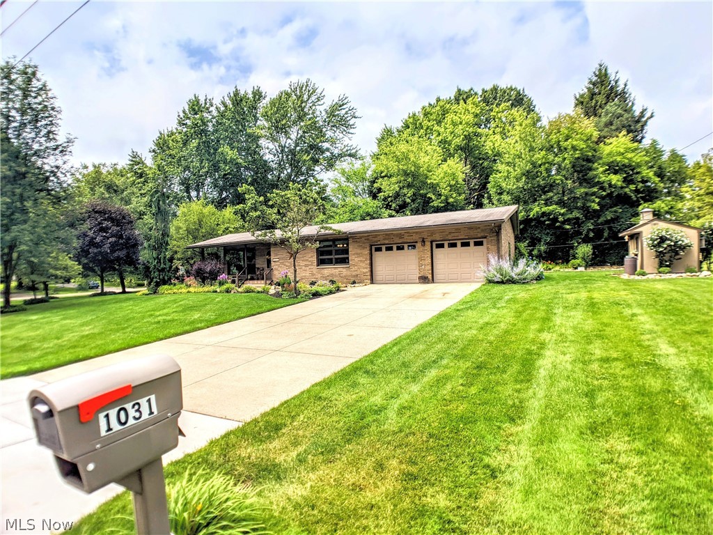 Fall in love with this well maintained home. Located on a generous corner lot in a quiet neighborhood, boasting front and back yard flagstone patios and a new (2020) Trex front porch, surrounded by established perennial gardens and trees, plus a relaxing water feature in the back yard. The 2 car attached garage is a handy man's dream, with water and heat, glass block windows plus access to the house and the back yard. Once inside, you will notice the extra large corner windows, fireplace with handcrafted mantle, golden oak floors and light, neutral paint throughout. Large eat in kitchen, with additional counter seating, full pantry, and custom honey oak cabinets. Kitchen redone in 2018 to include drawer pull-outs, soft close doors, ceiling can lighting, glass backsplash, 2 section stainless steel sink and faucet and new counter tops. Main floor has 2 bedrooms, full bathroom, and closets for storage. The owner's bedroom has large corner windows that look out onto the secluded back yard