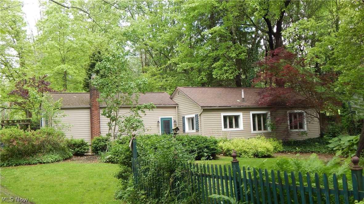 Hidden Away among Mature Trees and Beautiful Landscaping is this modified Ranch-style Home on a 1.85 Acre Lot with Barn and Workshop/Outbuilding located in Copley Township! Large Foyer/Dining/Sitting Room with ceramic tile flooring expands the living space outdoors to a professionally landscaped Private Rear Patio with Lilly Pond that provides an incredible view of the land. The warm and inviting Living Room has wood plank flooring and showcases a Brick Woodburning Fireplace - an Office/Media Room w/wood flooring is located off the LR and can be converted into a third Bedroom if you prefer. 16'X10' Eat-in Country Kitchen with ceramic flooring includes the range/oven & refrigerator. Master Bedroom has hardwood flooring, dual closets w/built-ins and mounted TV and is easily accessible to the remodeled Bathroom w/shower over tub and ceramic tile upgrades. Rear Patio (2014), Prodigy Insulated Vinyl Siding (2006), Roof (2007), Windows (2006) are only a few of the updates that come with