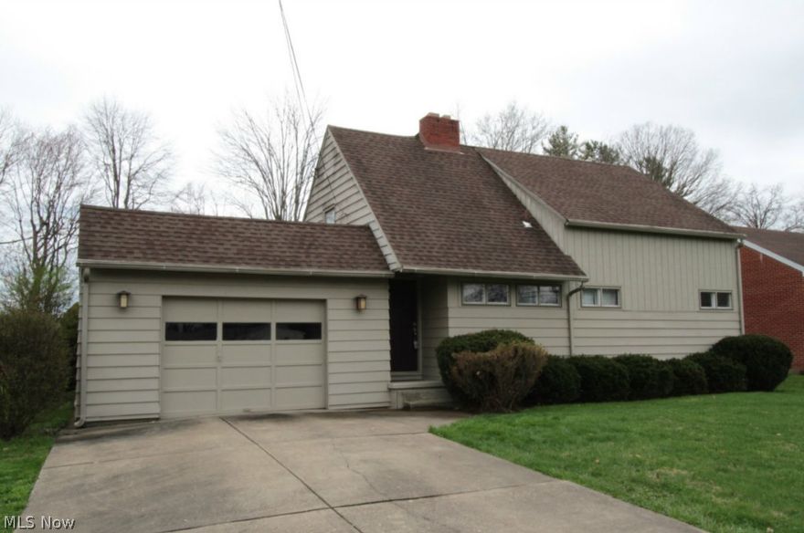 Well maintained home located in convenient north neighborhood.  Has newer 200 AMP electrical service, basement bathroom, range top & oven, & carpet. Roof approx. 10 years old; basement partially B-Dryed with warranty.  Huge living room with fireplace, could have dining room in one end. Pretty open staircase takes you to spacious upstairs bedrooms with wood floors.  Priced below tax value for quick sale. Great area close to Country Club, hospital, shopping etc. Big level backyard with covered patio. Extra refrigerator in garage stays. Call today. This won't last long! Price includes Home Warranty.