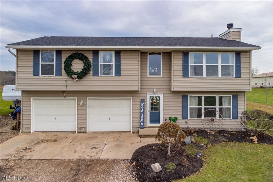 Welcome to country living in this beautiful Rootstown home! This well kept bi level home features 3 bedrooms and 2 full baths on the second level. You will also find a lovely modern open floor plan that features a living room, dining area, and kitchen on this same floor. If that is not enough, you will love the comforting feel on the first level that includes a spacious living area, 1/2 bath, and a fireplace for this cold winter days. If you're someone lives for the summer months, then you'll probably appreciate the above ground pool and deck in the back yard. There is also a 24x24 outbuilding & 2 car garage.  With 1.73 acres of land, this property has so much to offer. Updates include new roof (2020), new septic pump (2020), new well pump (2018), brand new first floor carpet, and also new carpet in one of the bedrooms. All kitchens appliances were purchased in 2017. This home won't last long! Come see it while you can!