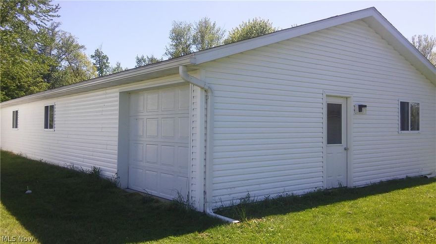 This would be a great place to have a workshop or store your collection of cars. There is a 30X40 commercial grade finished building with concrete floors, insulation and a garage door in the front and a single car garage door in the back. Then there is an additional 1-car detached garage.