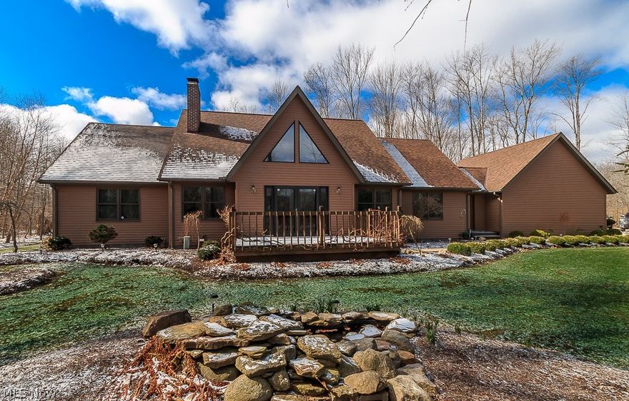 Be prepared to be wowed!!! If you are looking for a sanctuary-oasis to call home... look no further...  This picturesque open floor plan home is nestled on 5.5+ wooded private acres which feature waterfalls, ponds, and hot tub to name a few.   The sellers spared no expense when building this gorgeous home.  The landscaping alone will knock your socks off.  You will encounter dozens of varieties of plants including rare and unusual varieties from every nook and cranny of this haven you'll call home. Check out the Reverse osmosis kitchen sink and the Amish local harvested tongue in groove red oak floors.  Simply beautiful!  100 year old barn beam mantle is part of it's charm as well.   Anderson tilt & wash windows, walk in closet , new tile bathroom floors, and New Hunter ceiling fans decorate the kitchen, dining, family room and rear downstairs bedroom..  And there's MORE - Upgraded electric panel, upstairs deck, oversized garage, vector security alarm system, extra insulation over kitc